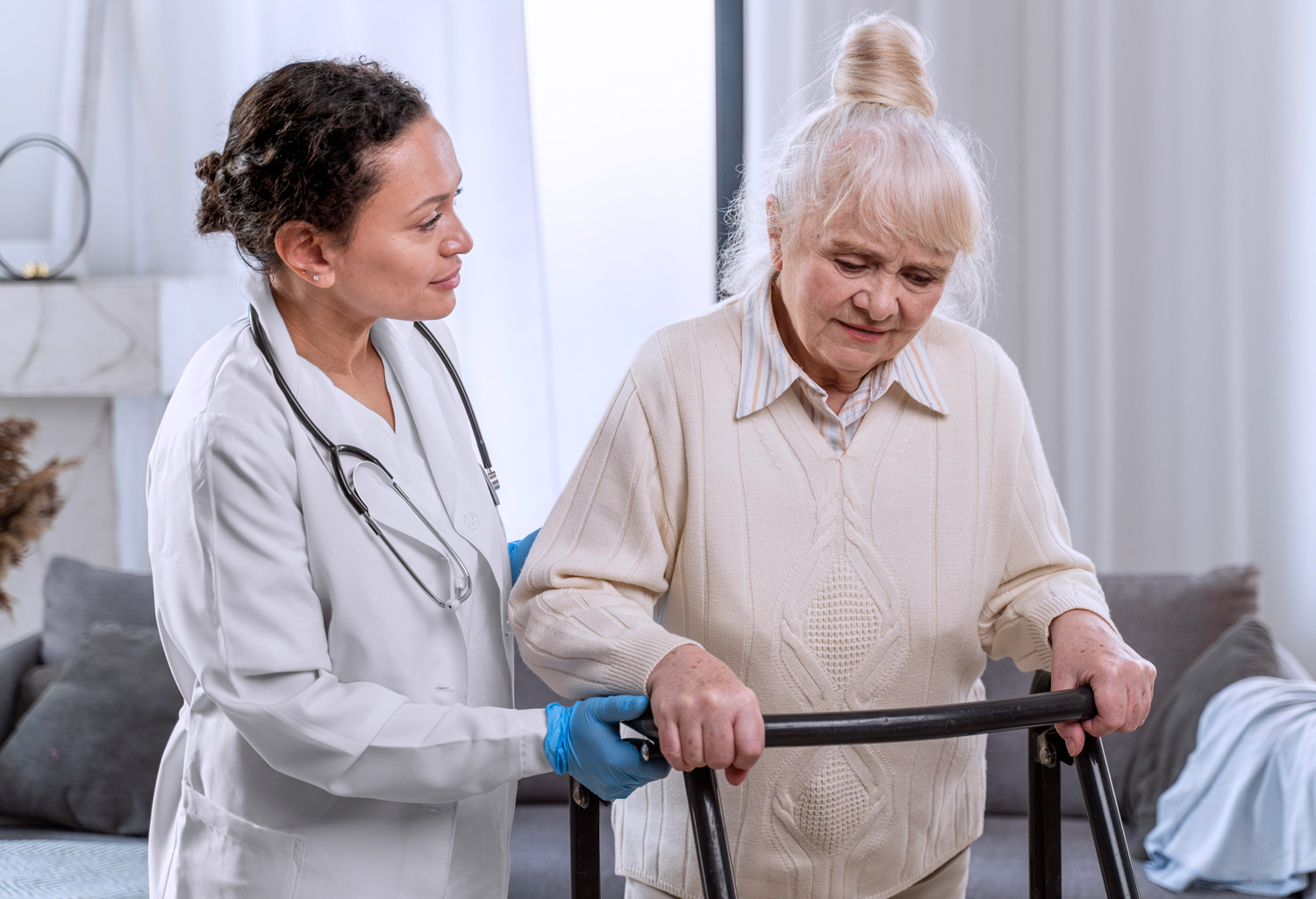Nurse assisting senior with walker.