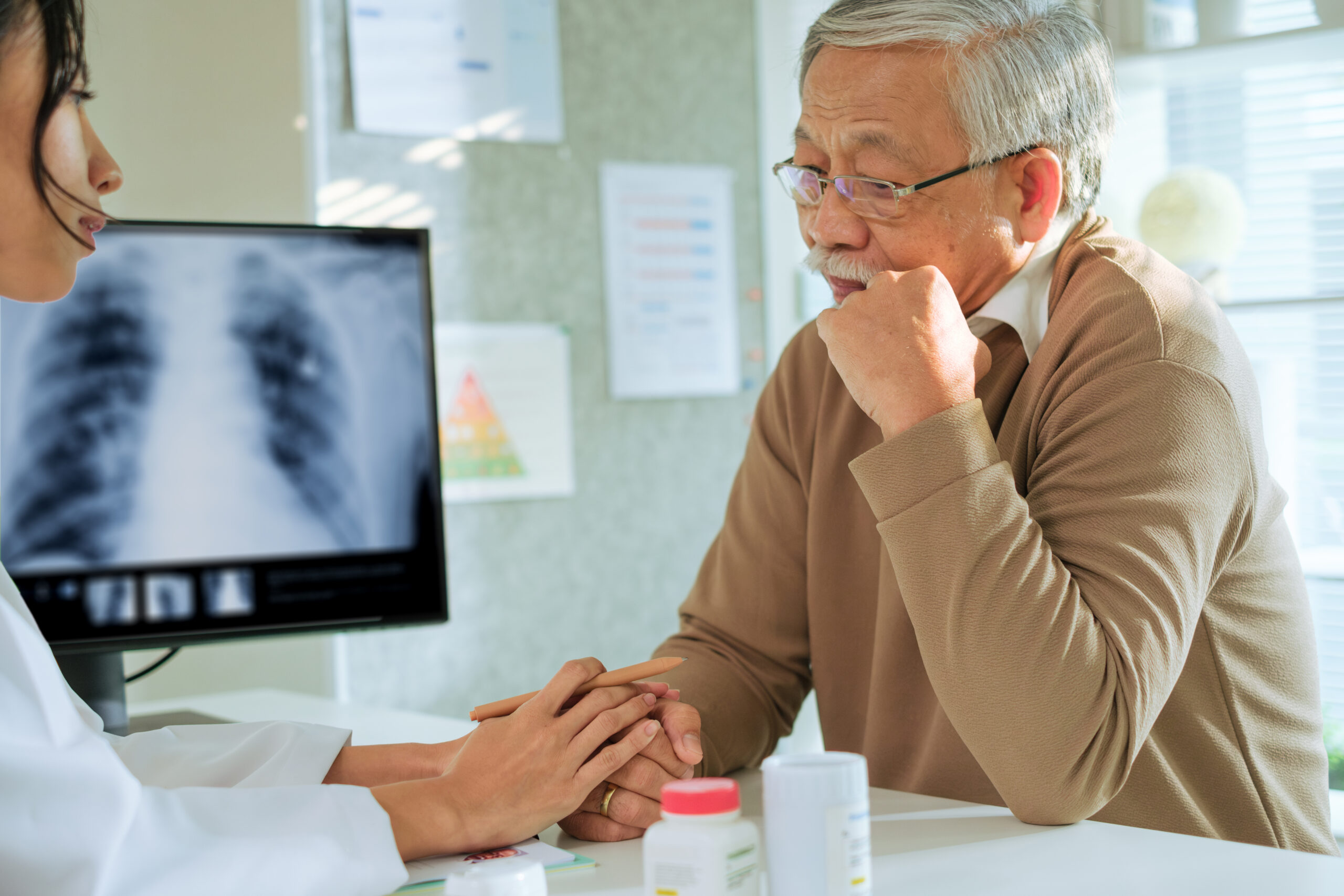 Doctor and senior patient in emotional health care counseling after diagnosis in hospital support setting