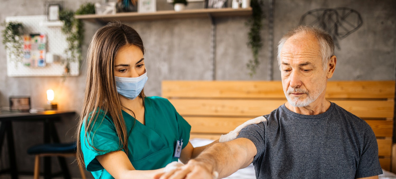 Healthcare worker assisting patient