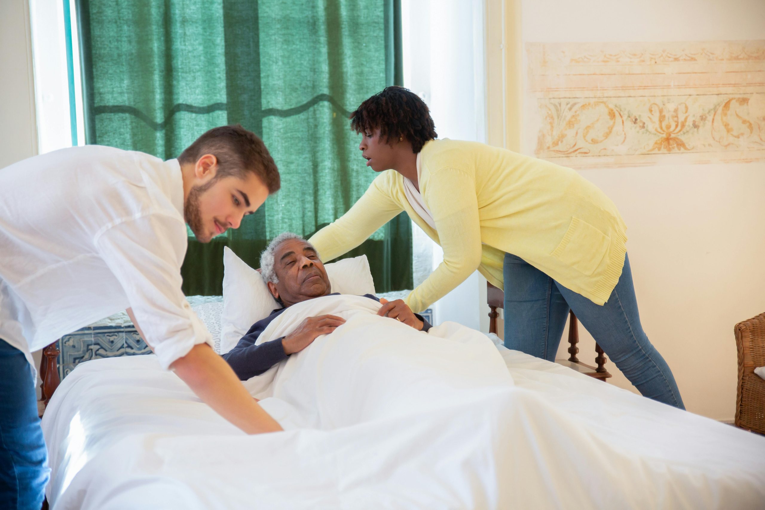 Elderly patient assisted in bed