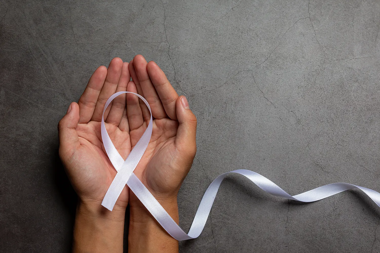 Hands holding ribbon